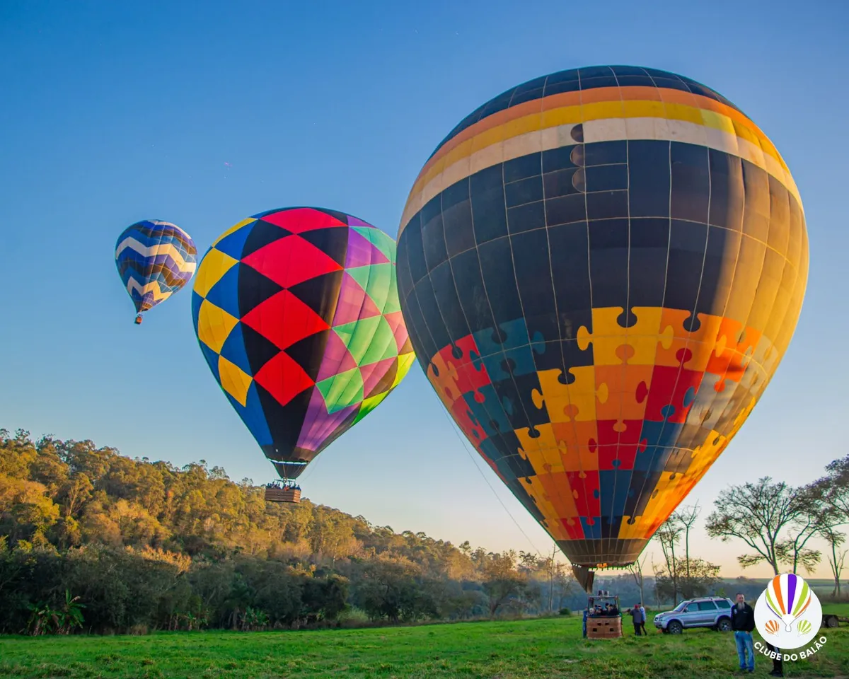Três balões decolando ao amanhecer